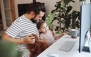 Vater und Tochter vor dem Bildschirm